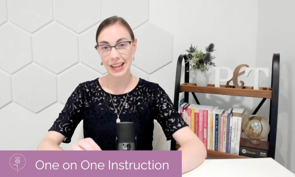 A woman sits at a table with a microphone and a bookshelf behind her. She is wearing a black dress. On the bottom left are the words "One on One Instruction" with the Pearl and Thistle logo in white on a pink background.