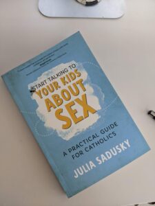 book sits on a desk. cover reads Start Talking to Your Kids About Sex