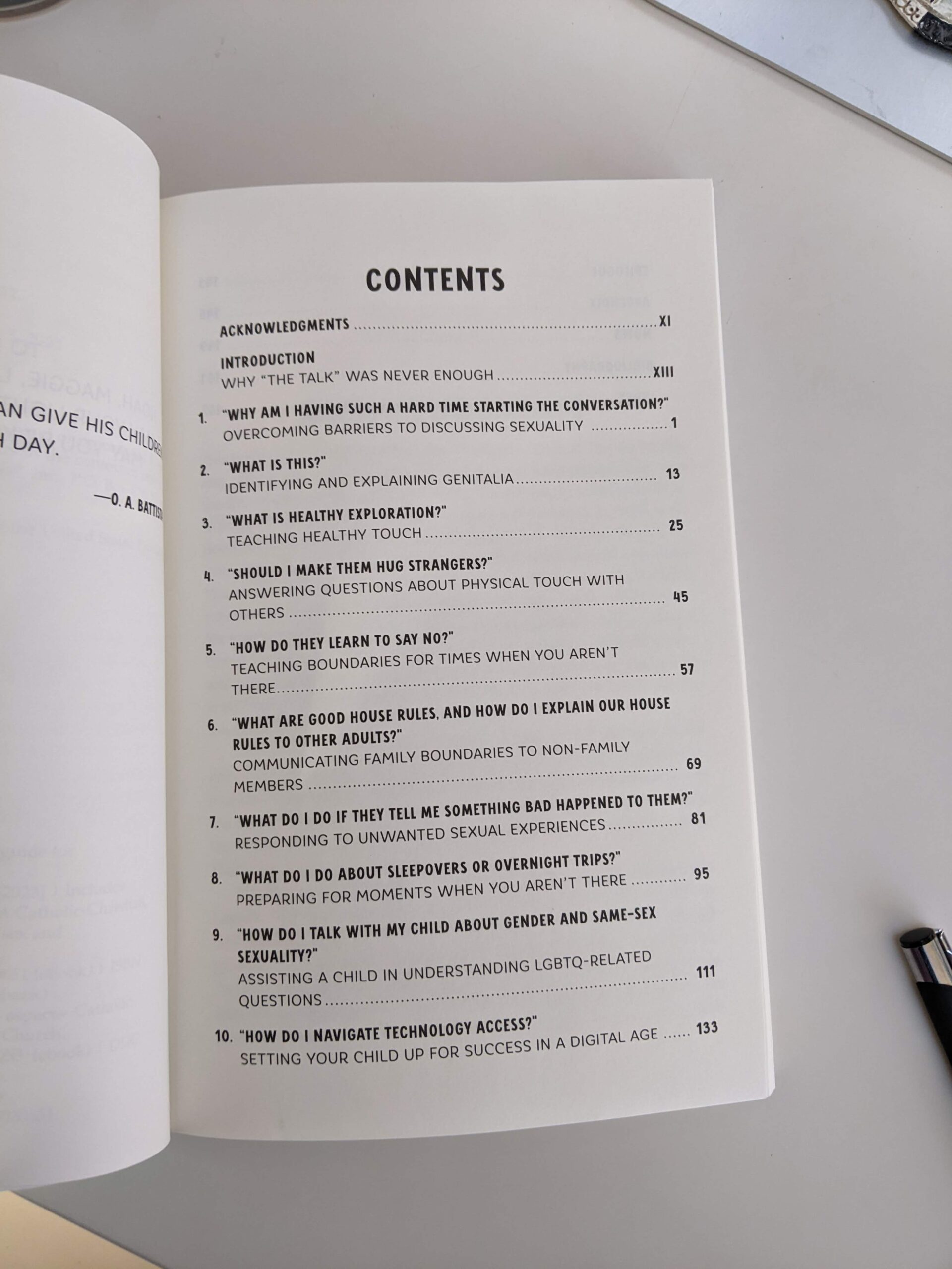 open book on a desk shows table of contents list for Dr Julia Sadusky's book on talking to your kids about sex