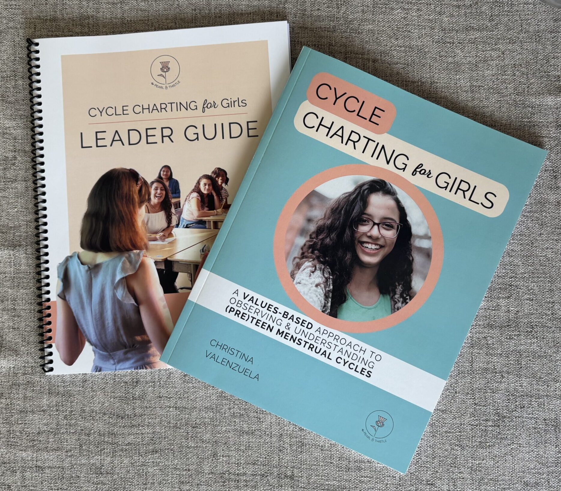 two books on table: Leader Guide and Cycle Charting for Girls